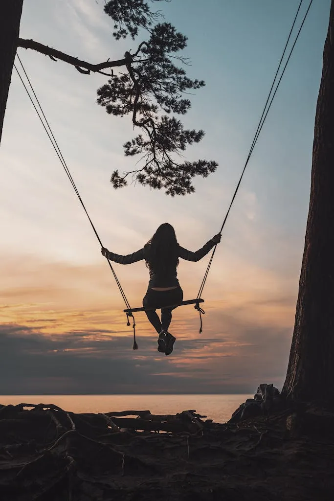 Person Sitting on Swing during Sunset, held by Polypropylene rope